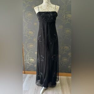 Black beaded sleeveless evening gown. Spaghetti straps. With attached overlay